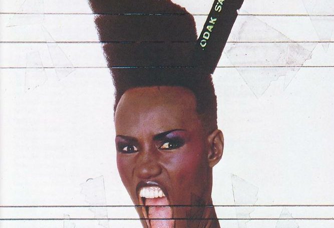 Photo of the amazing Grace Jones, from the cover of 'Slave to the Rhythym'. The photo has been collaged to make her mouth look very big and her hair look very tall.